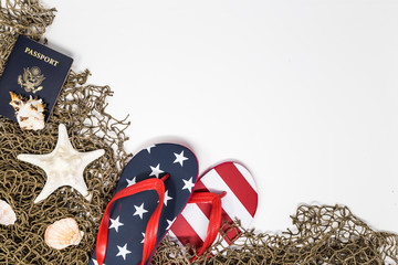 Star and Stripe design flip flop, US passport and seashells on white background.