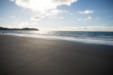Calm Ocean on beach in new zealand waiheke Island sandy sunny day in autumn  