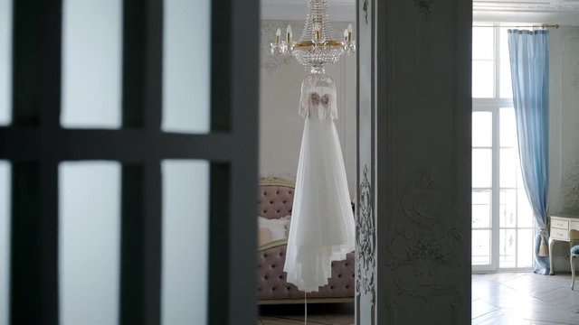 Wedding dress in bedroom on lamp