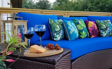 Red Wine-Filled Glasses with Cheese and Fruit Next to Tropical Outdoor Seating; Leisure Lifestyle Activities, Wine Tasting, Paradise, Travel, Upscale Amenities