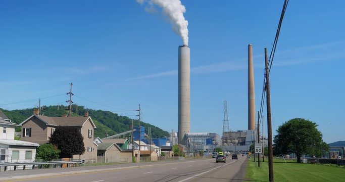 A daytime wide shot (DX) of traffic passing near the W.H. Sammis Power Plant on OH-7 along the Ohio River in eastern Ohio.  	