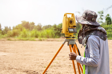 Surveyor engineer making measure at the land