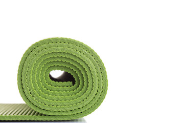 New green soft Yoga mat. Studio shot isolated on white