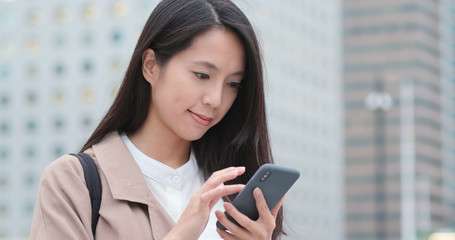 Woman use of mobile phone in city