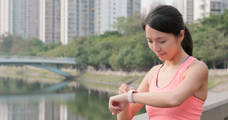 Sport woman checking the data on smart watch