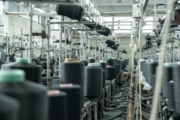 Fototapeta premium Old sewing manufacture, a factory, shop, a manufactory in work, a thread, machine tools.Old sewing manufacture, a factory, shop, a manufactory in work, a thread, machine tools.