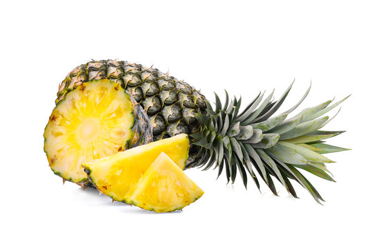 whole with slice ripe pineapple isolated on white background