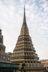 Fototapeta premium Pagoda is in Wat Pho that was named as the temple of the pagoda or chedi that are decorated with yellow glaze or glazed tiles or dark blue. 