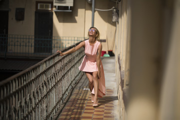 Blonde in a pink dress. Dances