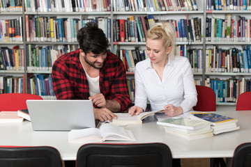 Students Using A Tablet Computer In A Library