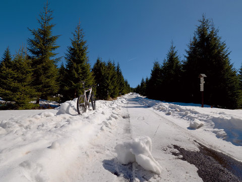 Cycling on large tyres in fresh snow. Biker goes by bike on the snowy road