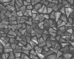 Naklejka premium Dry chopped firewood logs ready for winter as background or texture.