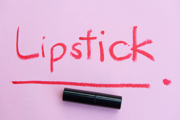 Red lipstick wording from lipstick on the pink background