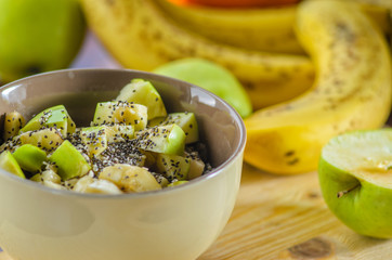 Healthy Breakfast Bowl: Oatmeal with Banana, Green Apple, Sesame and Chia Seeds
