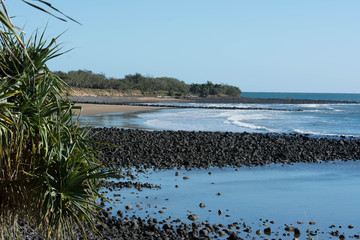 Basalt outcrop at waters edge in coastal community