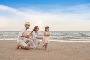 parent's hands and daughter holding private property in sea beach