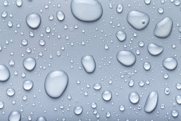 Drops of water on a color background. Gray