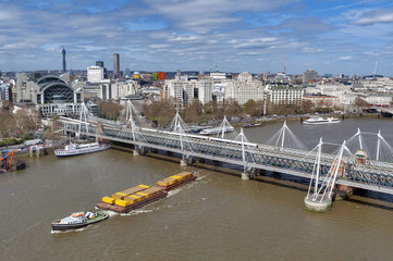 Aerial view of Hungerford Bridge, a steel truss railway bridge, flanked by the Golden Jubilee...