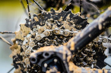 Mountain Bike Transmission in Mud. Dirty Chain Drive of Mountain Bike After Riding in Bad Weather