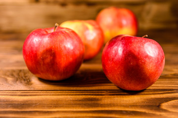 Ripe red apples on the wooden table
