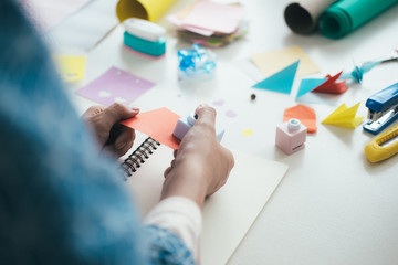 Handmade, the girl cuts out of paper.