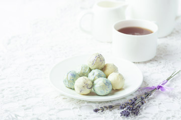 Round homemade sweets of white chocolate on the kitchen table. Morning tea. Copy space.