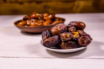 Date fruits on the white wooden table