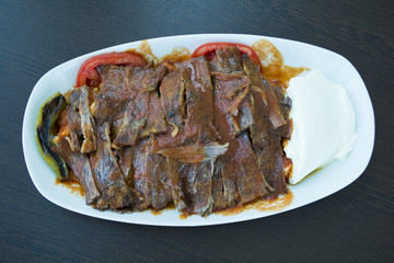 iskender kebab on a wooden surface at a restaurant top view.