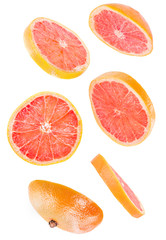 sliced flying grapefruit isolated on white background with clipping path. cut grapefruit in pieces isolated on white background. Levity fruit floating in the air