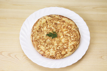 plate of potato omelette on the wooden table