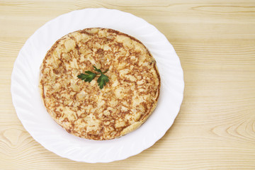 plate of potato omelette on the wooden table