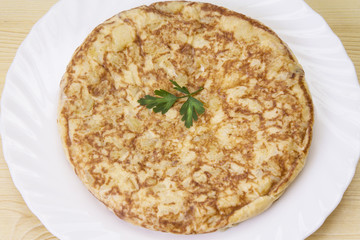 plate of potato omelette on the wooden table