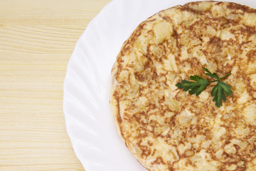 plate of potato omelette on the wooden table
