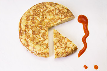 spanish potato omelette dish and tomato sauce