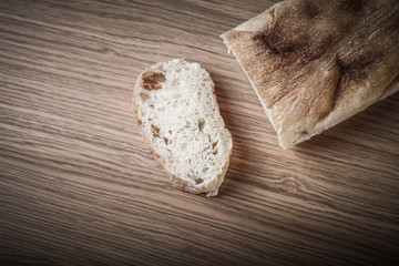 Fototapeta na wymiar Fresh bread on wooden cutting board. Toned