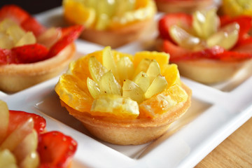 Fruit appetizers with fresh chopped orange fruit, grape and strawberry. Perfect summer dessert.