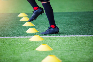 Kid soccer Jogging between marker cones