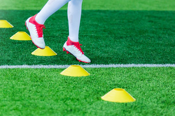 Kid soccer Jogging between marker cones
