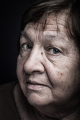 Studio portrait of elderly woman. Question. Toned