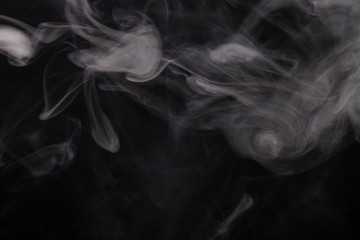 Cloud of smoke on black background. Selective focus