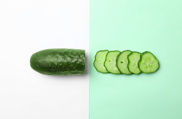 Flat lay composition with cut cucumber on color background