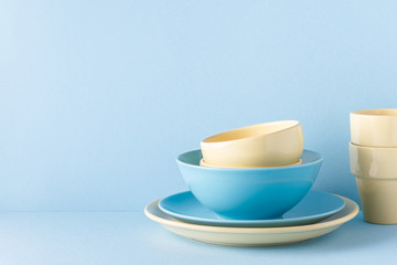 Crockery and cutlery on a blue pastel background