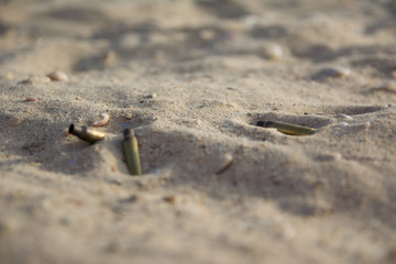 Shell casing of automatic weapons on the sand. signs of war