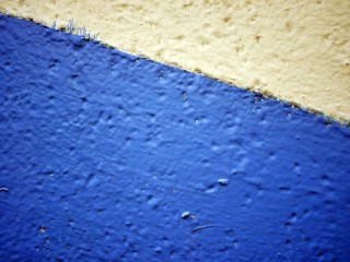 Bright rough texture of the iron wall, painted with contrasting tones