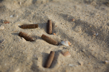 Shell casing of automatic weapons on the sand. signs of war