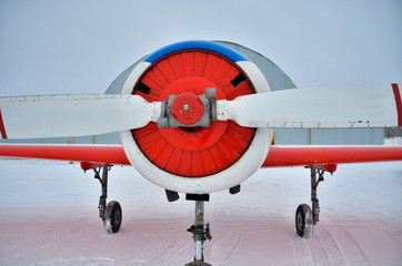 beautiful red-white plane with white blades ready for take-off