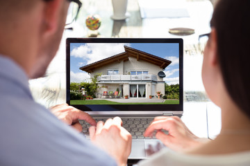 Two Businesspeople Looking At House