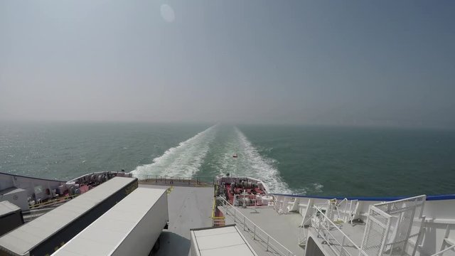 Dover Cliffs filmed from the ferry with gulls flying behind the boat