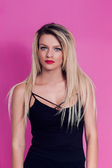 Fototapeta premium Woman portrait with long blonde hair looking at camera