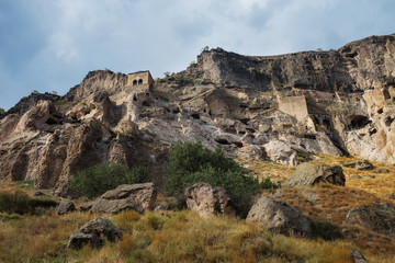 Fototapeta na wymiar Monastery of Vardzia. Stones in the background of the cave city. Landscape. Journey to Georgia.
